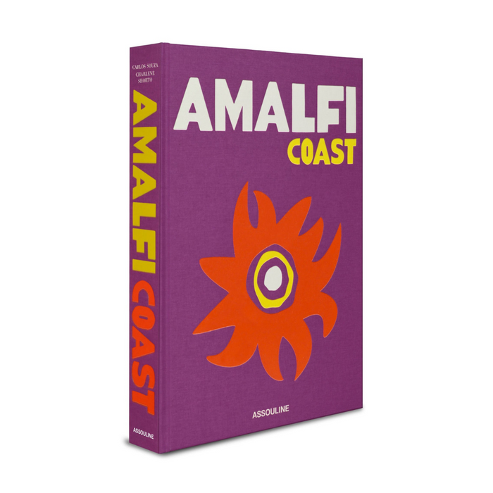 The Amalfi Coast Book by Assouline features bold white and yellow text on a purple cover with an abstract orange and yellow floral design; the author and Assouline appear on the spine and cover.