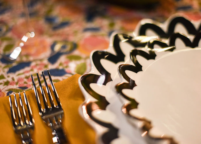 Cropped Close up of Black Arabesque Trim Scallop Salad Plate in Individual Place Setting