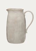 A white ceramic pitcher.