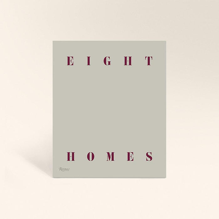 Pale green book cover with the words EIGHT HOMES in dark red capital letters
