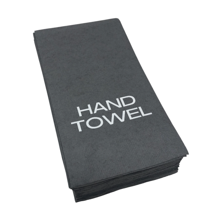 A stack of folded pewter guest hand towels by Print Appeal, each with "HAND TOWEL" in bold white letters—ideal for display in an acrylic guest towel holder.