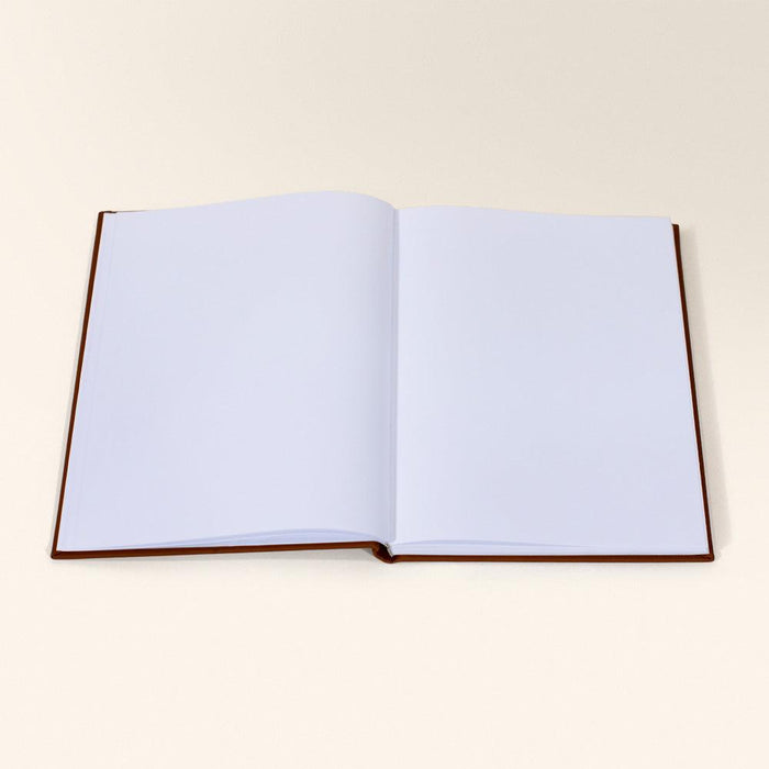 Large open chestnut brown sketchbook with blank white pages lying flat on a white surface