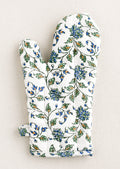 A quilted white cotton oven mitt with blue, green and orange floral pattern.