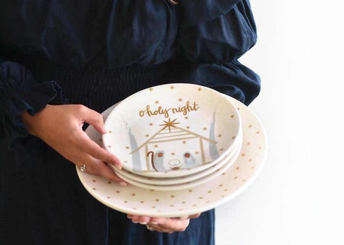 Front View of Woman Holding Stack of O Holy Night Design Plates