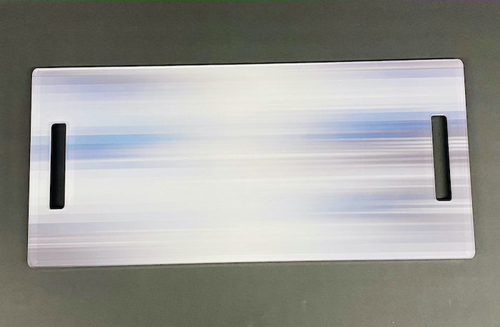 The Eye Candy Serving Long Board | Blurred Lines is a rectangular, slightly iridescent acrylic board with two hand slots and a blue-white gradient, ideal as a serving platter for your kitchen island.