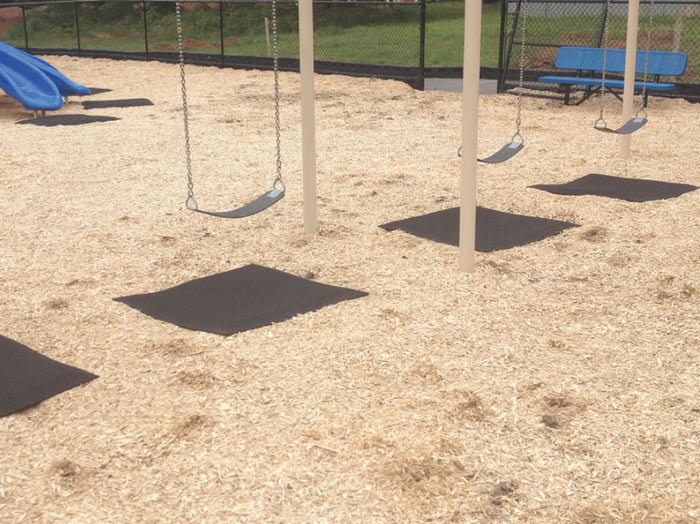 Swing and Slide Rubber Playground Mat under swings on mulch surface with blue slide and bench in background