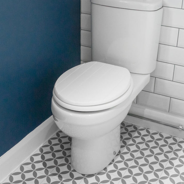 White soft-close tongue and groove MDF wood toilet seat showing seat in place on a white ceramic toilet